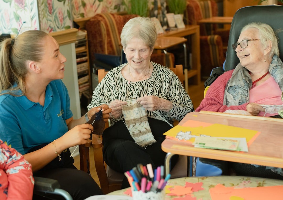 services-03 caregiver-assists-two-elderly-women-knitting-gstffdroygo